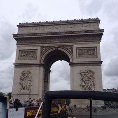 the people are walking around in front of the arc de trioe triumphal arch