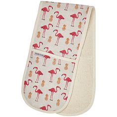 an oven mitt with flamingos on it and pineapples in the background