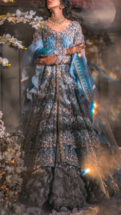 a woman in a blue and silver gown