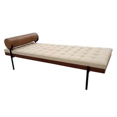 a brown and white bench with a leather cushion on it's back end, against a white background