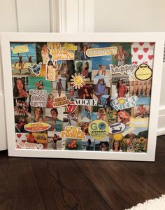 a white frame filled with pictures and stickers on top of a wooden floor next to a door