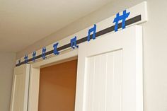 blue tape is taped to the side of a white door with an arrow on it