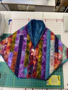 a quilted jacket sitting on top of a cutting board