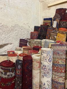 a pile of rugs sitting next to each other in front of a white wall