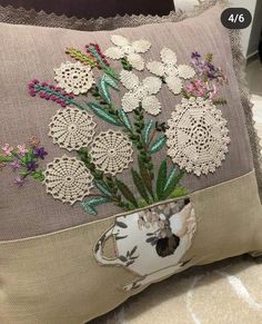 an embroidered pillow with flowers on it