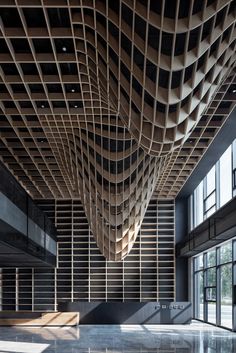 the interior of an office building with large windows and wooden slats on the ceiling