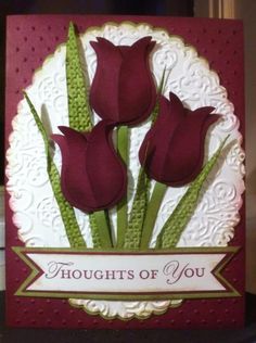 a card with three red flowers on it