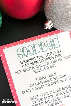 an ornament and christmas ornaments on a table with a good bye card in front