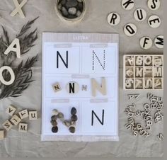 letters and numbers are laid out on a table with some type of magnets in them