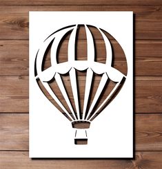 a paper cutout of a hot air balloon on a wooden background with the word love written