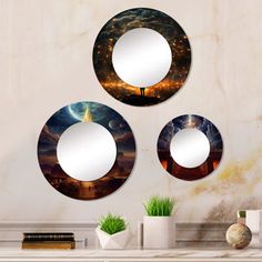 three circular mirrors hanging on the wall above a table with vases and plants in front of it