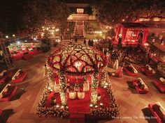 an elaborately decorated christmas display in the middle of a courtyard with candles and decorations