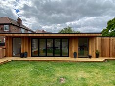 a wooden house with large sliding glass doors