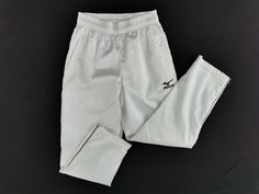 a pair of white shorts and pants on a black surface