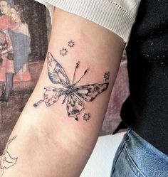 a woman's arm with a butterfly tattoo on it