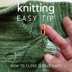 a hand holding an orange pair of scissors next to a green knitted sweater with the words knitting easy tip on it