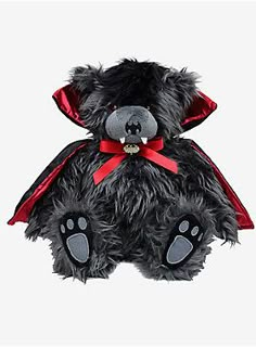 a black teddy bear with a red ribbon around its neck