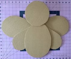 four circles are placed on top of a piece of crafting paper and ready to be cut