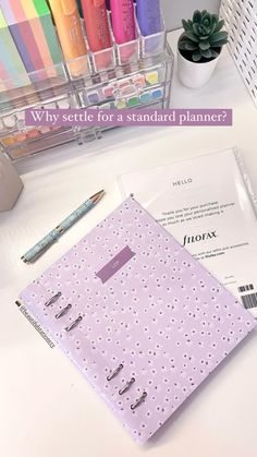 a white desk topped with lots of different colored pens and paper next to a pen holder