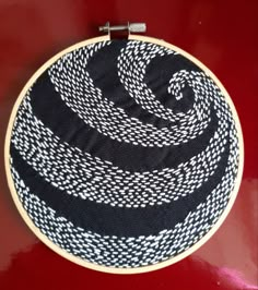 a black and white basket sitting on top of a red table