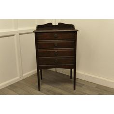 an antique chest of drawers in the corner of a room with wood floors and white walls