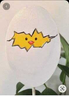 a white lollipop with two yellow birds on it