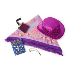 a purple hat, scarf and book on a white background