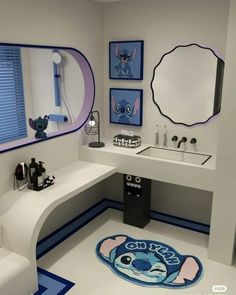 a bathroom with blue and white decor on the floor, sink and mirror in it