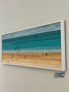 a painting hanging on the wall with blue and green stripes in it's center