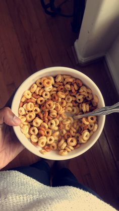 a person is holding a bowl of cereal