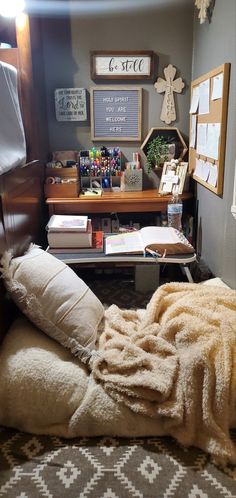 a bedroom with a bed, desk and books on the shelves next to each other