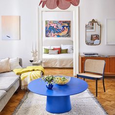 a living room filled with furniture and a blue table