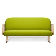 a green couch sitting on top of a white floor next to a wooden frame chair