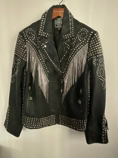 Double d ranch   rhinestone cowboy  2020 nashville  100% sheep , fully lined  dripping with tons of glitz and    rhinestones , hook eye closures  . the word     ''' cowboy ''' on back in glitz  .. size   2x  unisex ..    dripping with  fringed crystals  , this amazing jacket    is ine not to let go .. comes with  ddr coat bag .       ddr wooden hanger  .. has been stored and     packed away  ,,great gift Black Rhinestone Jacket, King Clothes, Black Alpaca, Rhinestone Jacket, Rhinestone Cowboy, Cowboy Jacket, Battle Jacket, Nashville Style, Double D Ranch