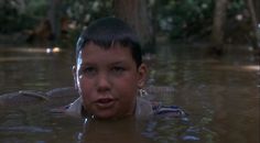 a young boy is submerged in the water