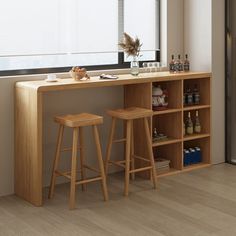 two wooden stools sitting next to a bar with bottles on it and a window in the background