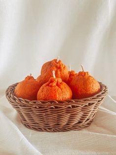 a basket filled with oranges sitting on top of a white table