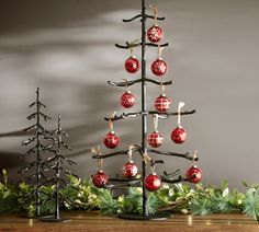 a christmas tree with ornaments hanging from it's branches and decorations on the top