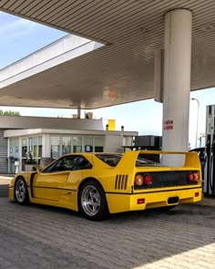 a yellow sports car parked in front of a gas station with no one around it