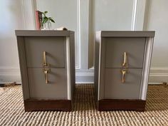 two metal drawers sitting on top of a carpeted floor