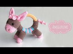 a crocheted toy horse with a wooden ring