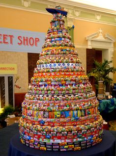 a very large christmas tree made out of many different types of candy bar wrappers