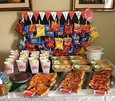 a table topped with lots of pizza and snacks