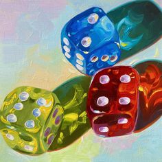 three colorful dices sitting on top of each other in front of a blue background