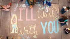 children sitting on the ground with chalk written in front of them that says i'll walk with you