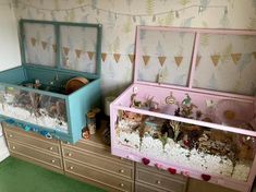 two toys are sitting on top of the dressers in this playroom, one is filled with sand and water