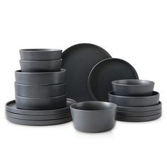 a stack of grey dishes and cups