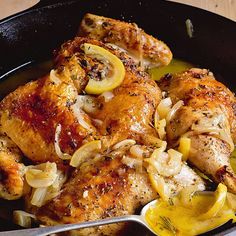 chicken with onions and lemons in a skillet