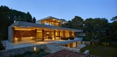 a modern house is lit up at night