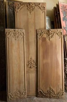 three wooden doors sitting next to each other